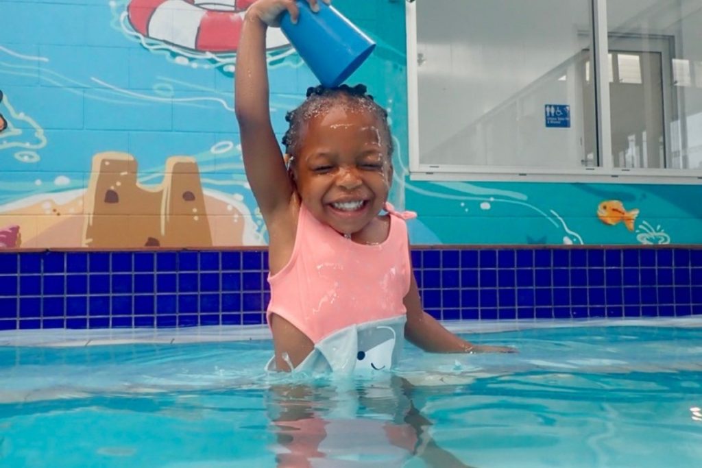 child laughing with joy in the water